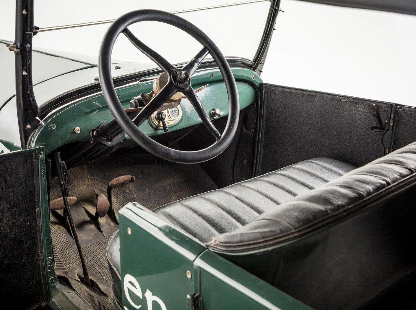 Puesto de manejo de un Ford T, con el volante, el tablero y las dos palancas bajo el volante